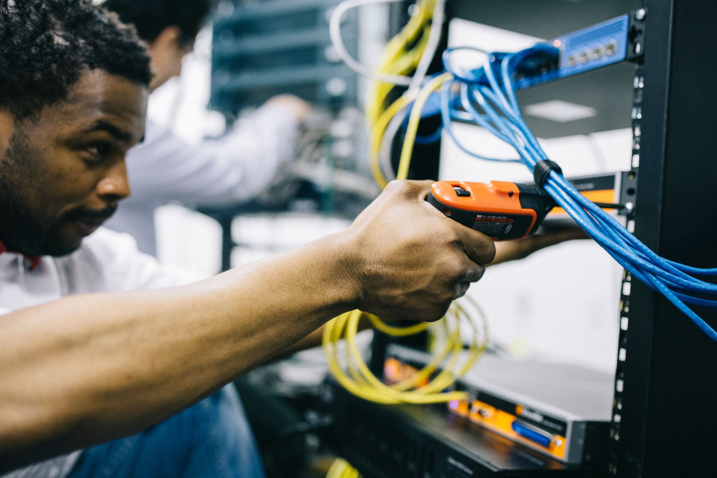 Network technician checking neatly arranged server-room cables